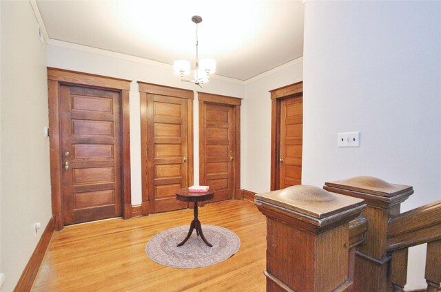 office featuring light hardwood / wood-style flooring, ornamental molding, and a notable chandelier