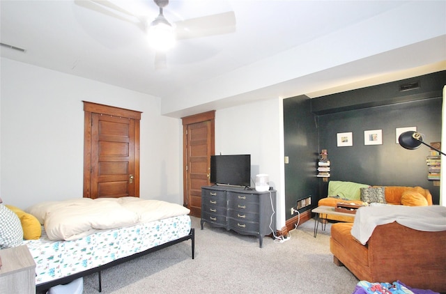 bedroom with light carpet, visible vents, baseboards, and ceiling fan