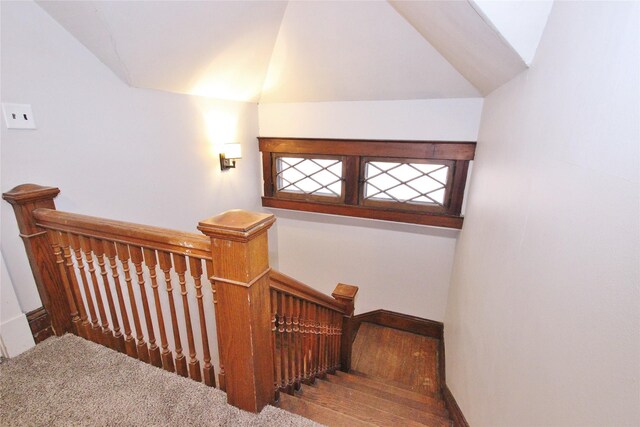 stairs with carpet and vaulted ceiling