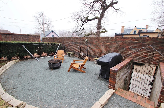 exterior space with a fenced backyard and an outdoor fire pit