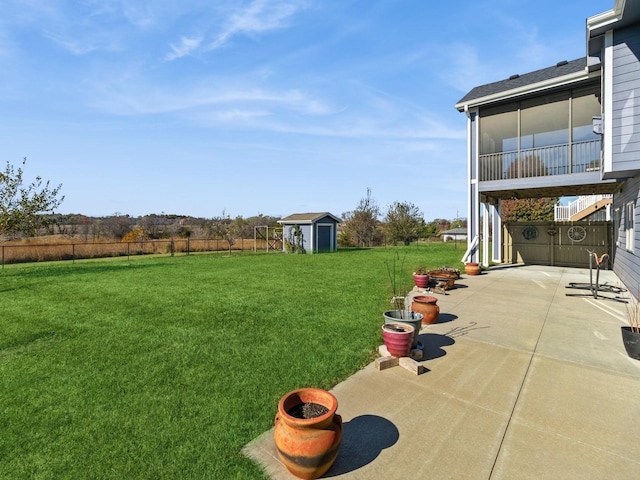 view of yard with a patio and a storage unit