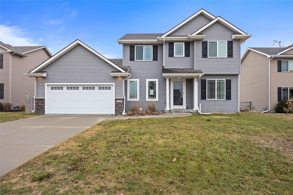 view of front of home featuring a garage and a front lawn