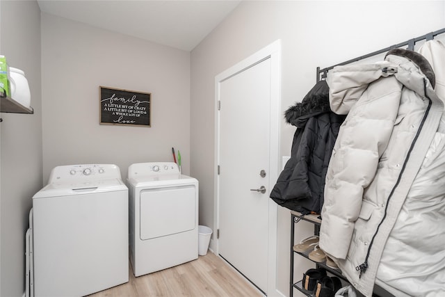 washroom featuring light hardwood / wood-style flooring and washing machine and clothes dryer