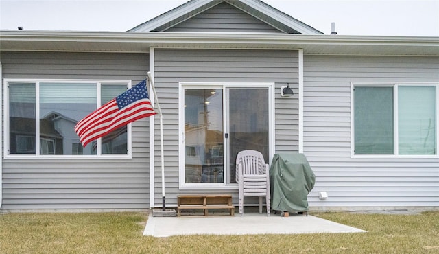 back of house featuring a lawn and a patio