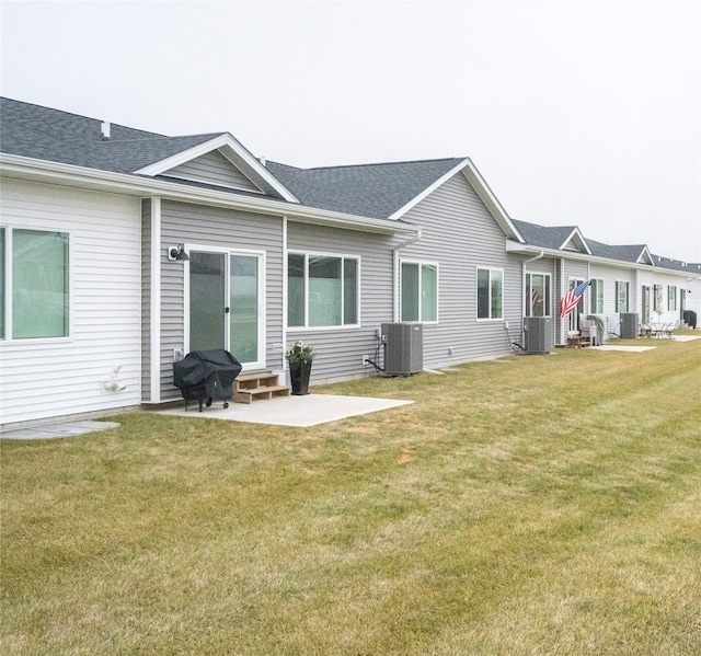 back of house with a yard, a patio, and central AC