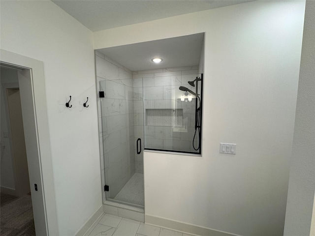 full bathroom featuring marble finish floor, a stall shower, and baseboards