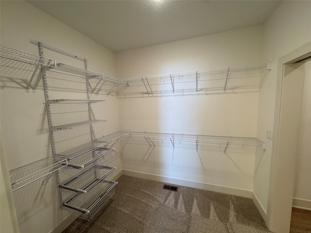 walk in closet with carpet flooring and visible vents