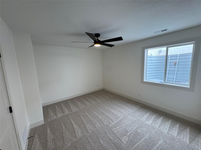 unfurnished room featuring visible vents, a ceiling fan, light carpet, a textured ceiling, and baseboards