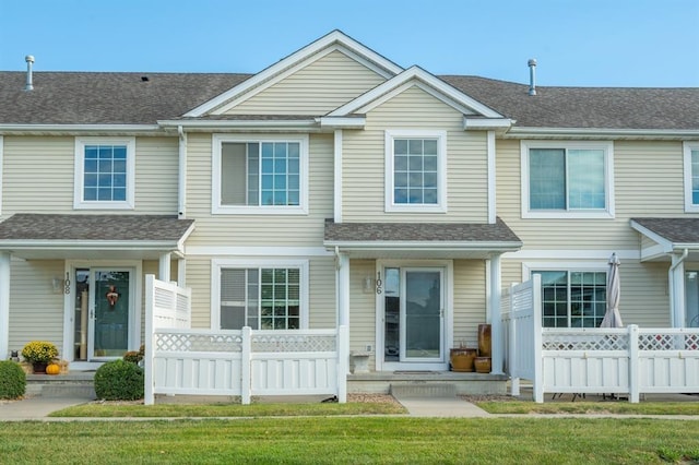 view of property featuring a front lawn