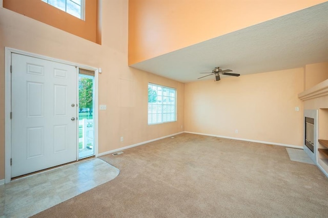 entryway featuring ceiling fan and light colored carpet