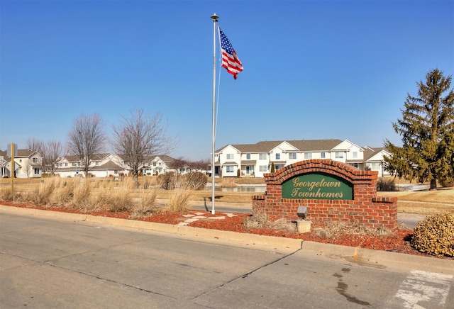 community / neighborhood sign with a residential view