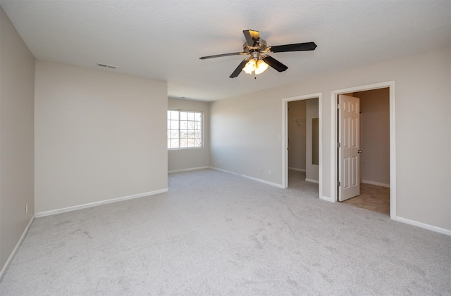 interior space featuring carpet flooring, visible vents, and baseboards