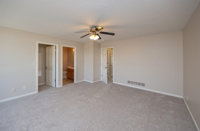 unfurnished bedroom featuring baseboards, visible vents, and a textured ceiling