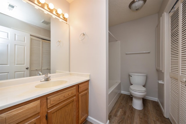 full bathroom featuring toilet, visible vents, a closet, and vanity