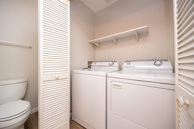 laundry area featuring laundry area, wood finished floors, and washing machine and dryer