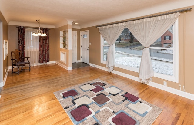 interior space with hardwood / wood-style floors and a notable chandelier