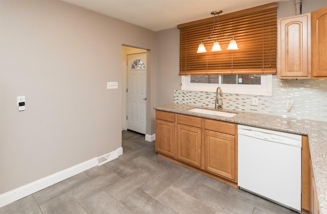 kitchen featuring light stone countertops, backsplash, white dishwasher, sink, and hanging light fixtures