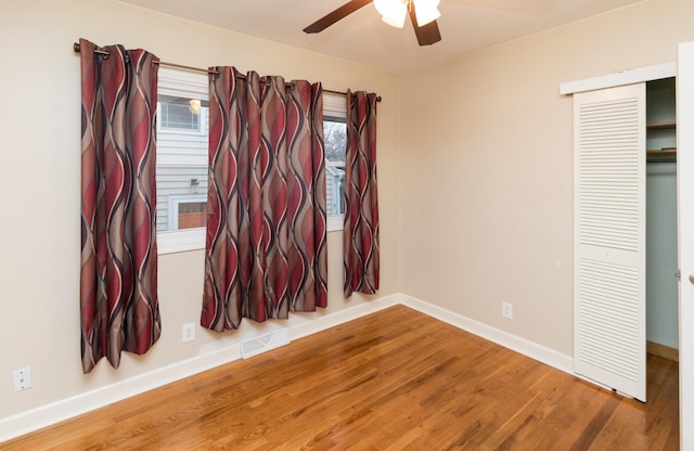 unfurnished bedroom with a closet, ceiling fan, and hardwood / wood-style floors