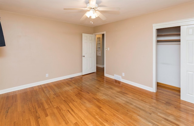 unfurnished bedroom with a closet, light hardwood / wood-style flooring, and ceiling fan