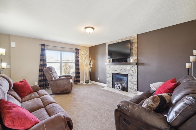 carpeted living room with a stone fireplace