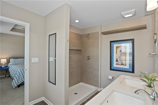 bathroom with vanity and tiled shower