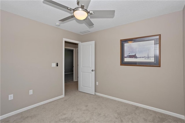 unfurnished room featuring ceiling fan and light colored carpet