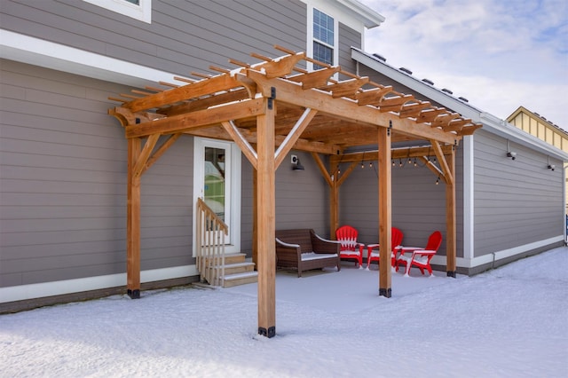 snow covered patio with a pergola