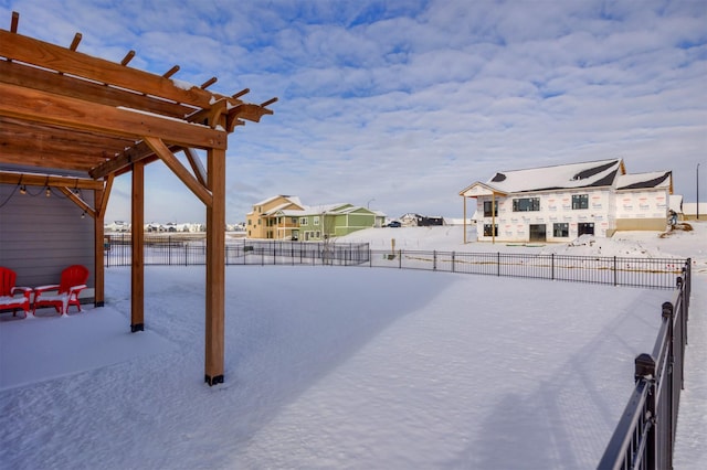 yard layered in snow with a pergola