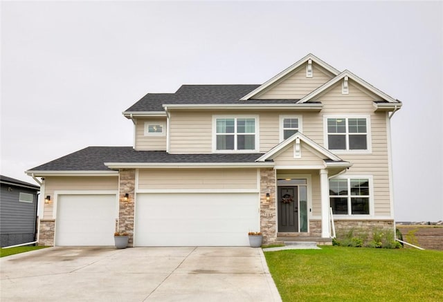 craftsman-style house featuring a front yard and a garage