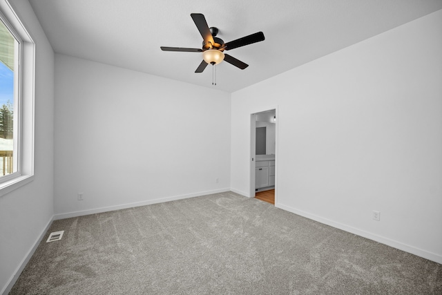 carpeted empty room with ceiling fan