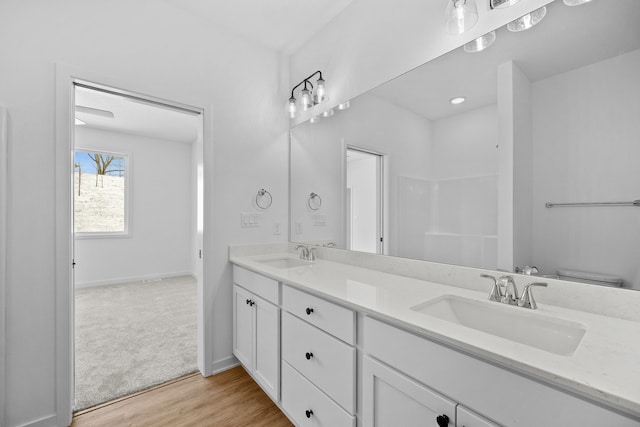 bathroom featuring hardwood / wood-style floors, vanity, and toilet