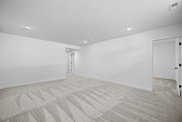 unfurnished room featuring light carpet