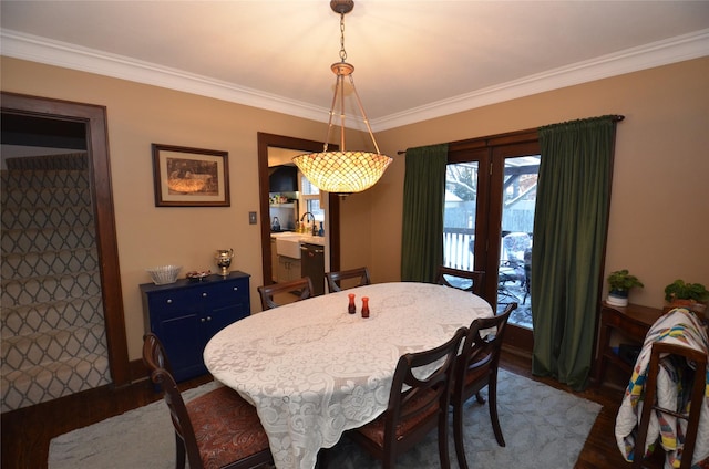 dining area featuring crown molding and dark wood-type flooring