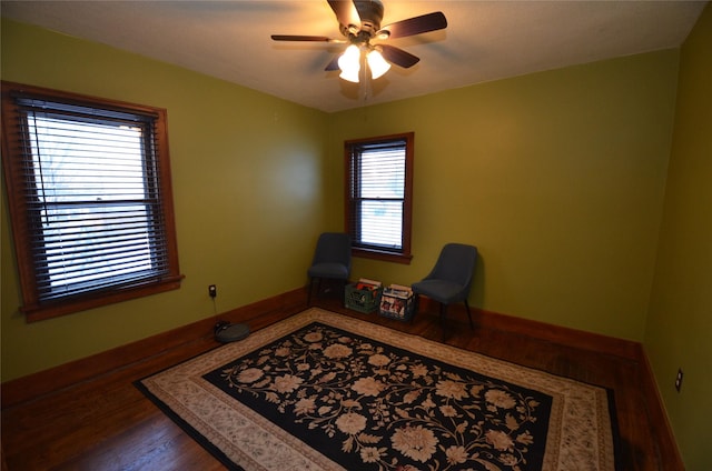 living area with hardwood / wood-style flooring and ceiling fan