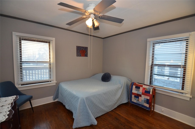 bedroom with ceiling fan, crown molding, and dark hardwood / wood-style floors