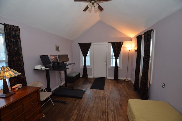 exercise room featuring ceiling fan, dark wood-type flooring, and lofted ceiling