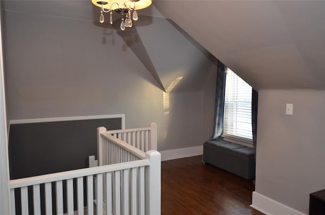 bonus room with vaulted ceiling, a chandelier, and dark hardwood / wood-style floors