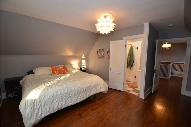 bedroom with lofted ceiling and dark wood-type flooring