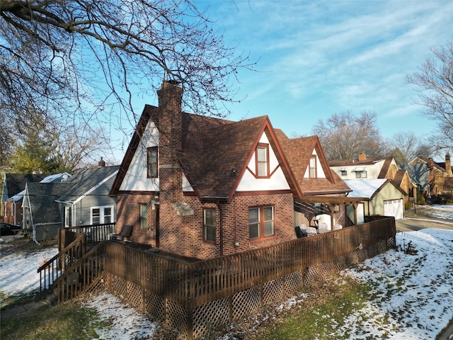 exterior space featuring an outbuilding, a garage, and a deck