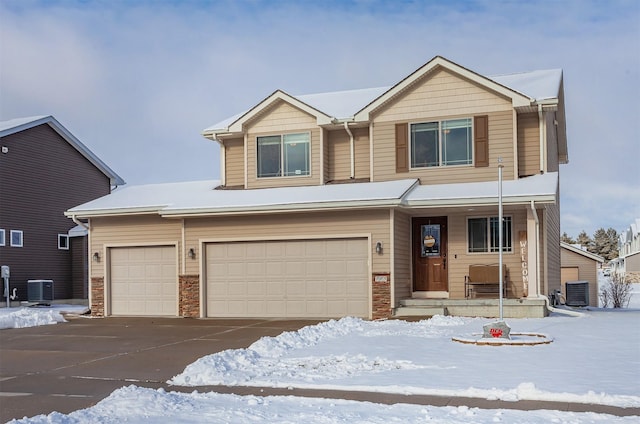 view of front of property featuring central AC and a garage