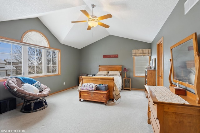 carpeted bedroom featuring ceiling fan, lofted ceiling, and a textured ceiling