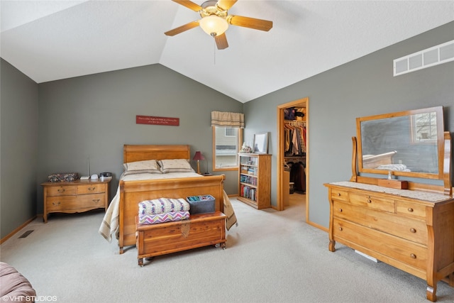 carpeted bedroom featuring vaulted ceiling, a closet, a spacious closet, and ceiling fan