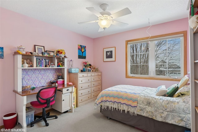 carpeted bedroom with ceiling fan and a textured ceiling