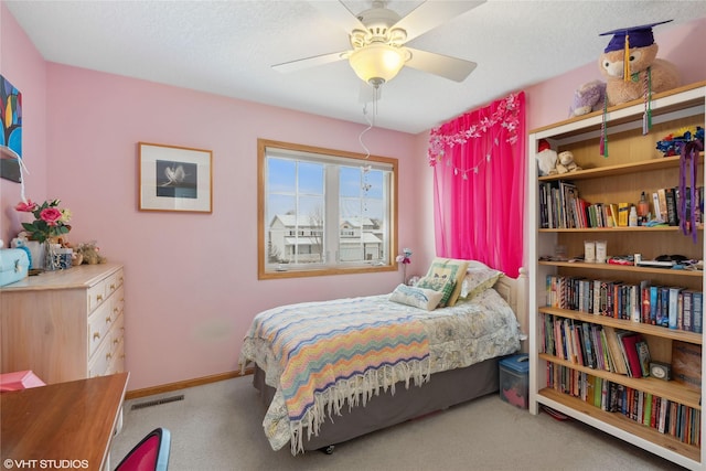 bedroom with a textured ceiling, carpet floors, a closet, and ceiling fan