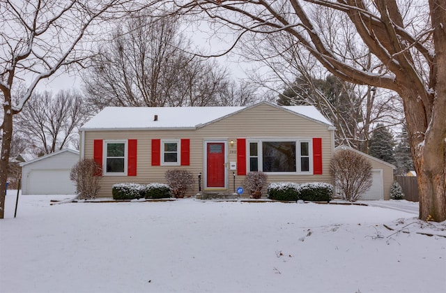 ranch-style home with an outbuilding and a garage