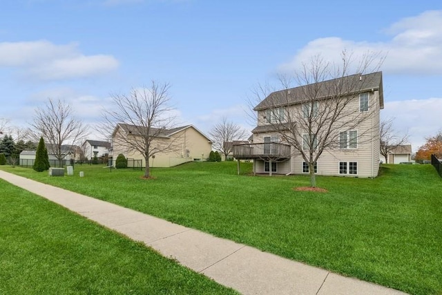 exterior space featuring a wooden deck and a lawn