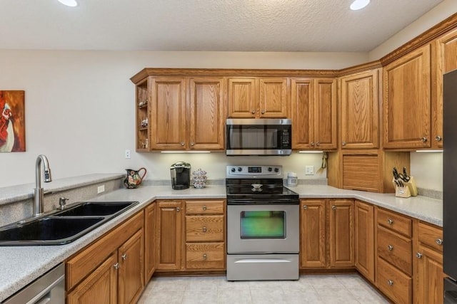 kitchen featuring a textured ceiling, sink, and stainless steel appliances