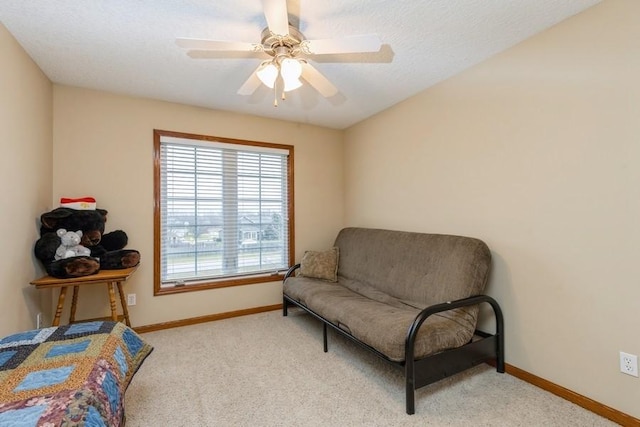 sitting room featuring ceiling fan and light carpet