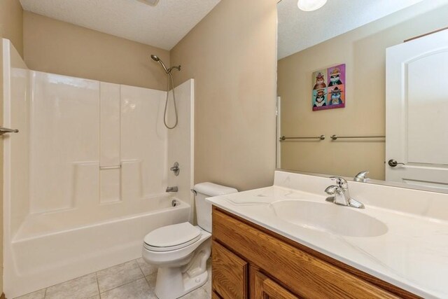 full bathroom with vanity, tile patterned flooring, toilet, a textured ceiling, and tub / shower combination