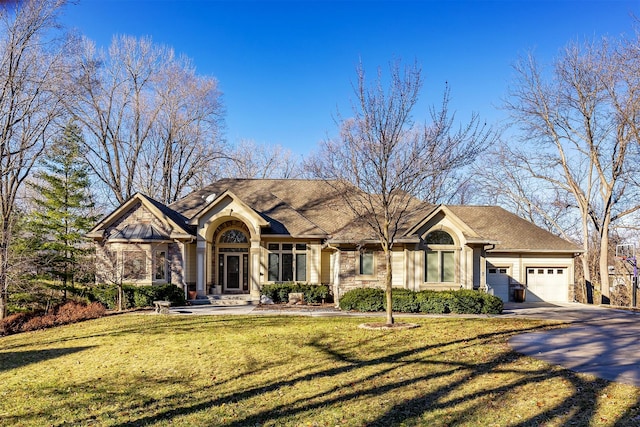 view of front of home with a front lawn and a garage